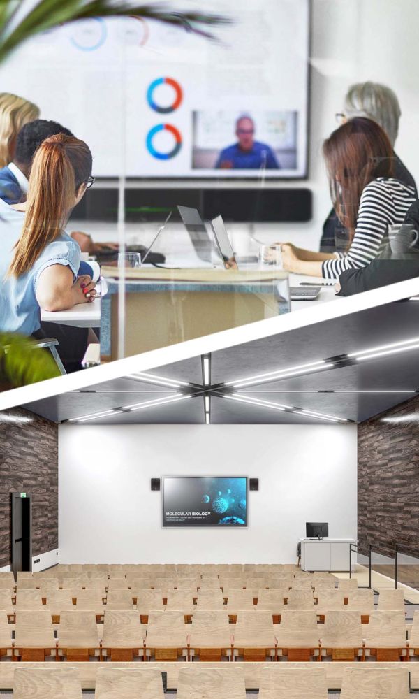 Woman in orange blouse writing in notebook in front of computer