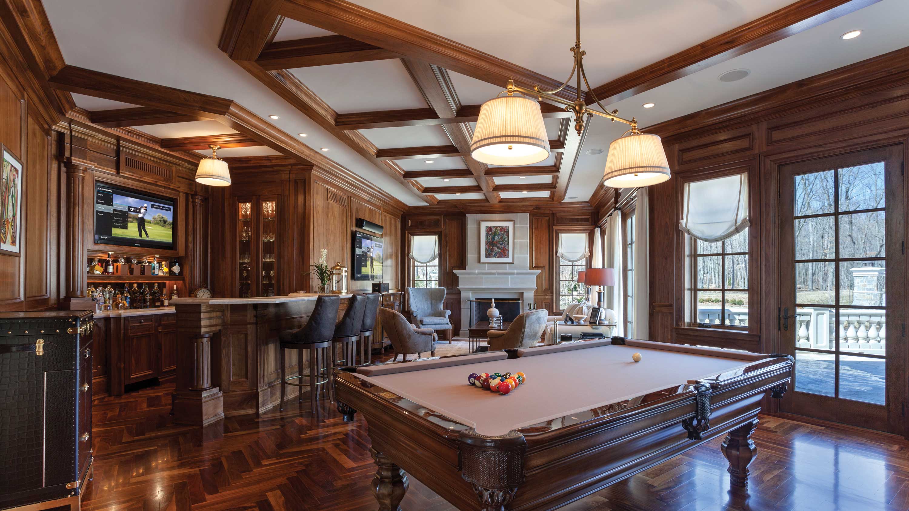 crestron technology in a home bar with wood accents