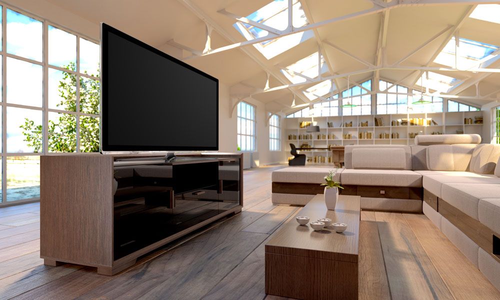 Salamander Designs tv on wooden console table in room with large windows