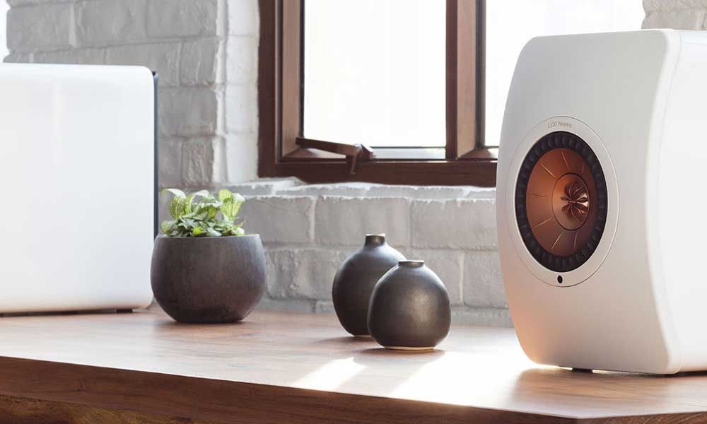 KEF speakers in white on wooden table